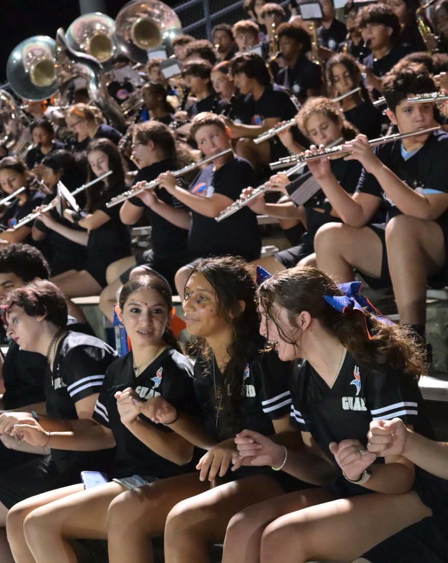 West Orange band and color guard students performing in the stands.