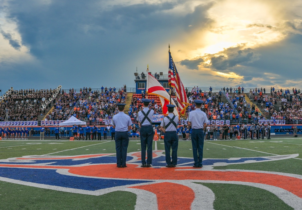 Color guard standing on the West Orange field during the pregame ceremony.