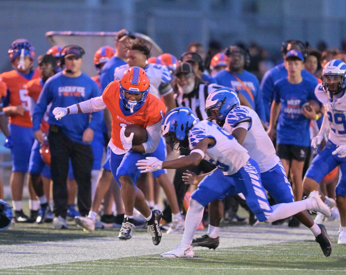West Orange Warriors ball carrier cutting upfield during a football game.