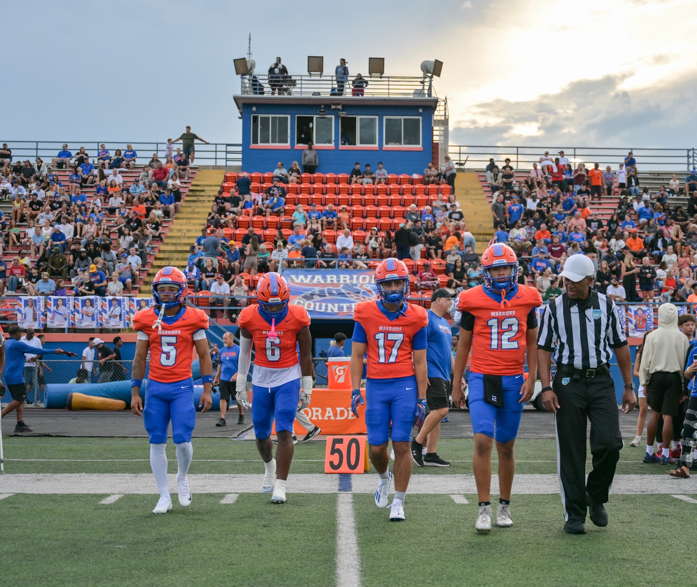 West Orange Warriors captains walking at midfield before kickoff.
